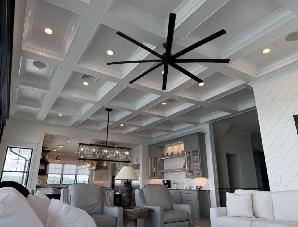 Open living room with coffered ceiling and trim detail by Heavin Trim Carpenters