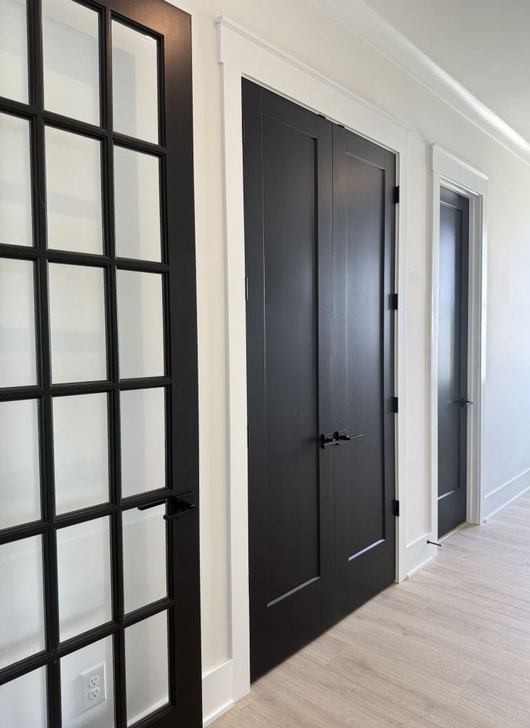 Dark-stained interior doors hung by Heavin Trim Carpenters