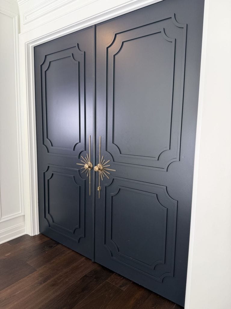 Decorative door hardware on a panelled double door installed by Heavin Trim Carpenters